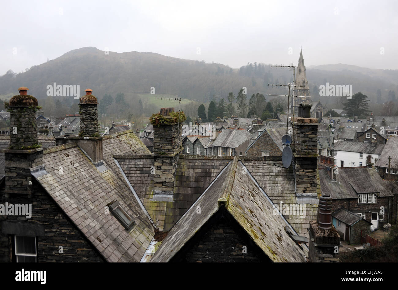 Grey slate roofs on a dull misty day at Ambleside in The Lake District Cumbria UK Stock Photo