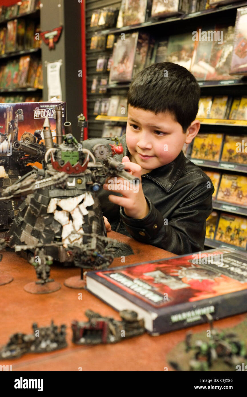 young boy looking at games in games workshop Stock Photo