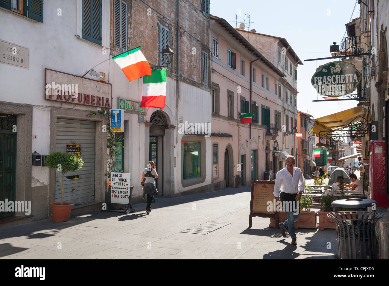 Street with Italian flags at Corso Garibaldi in Ariccia with street restaurant. Stock Photo