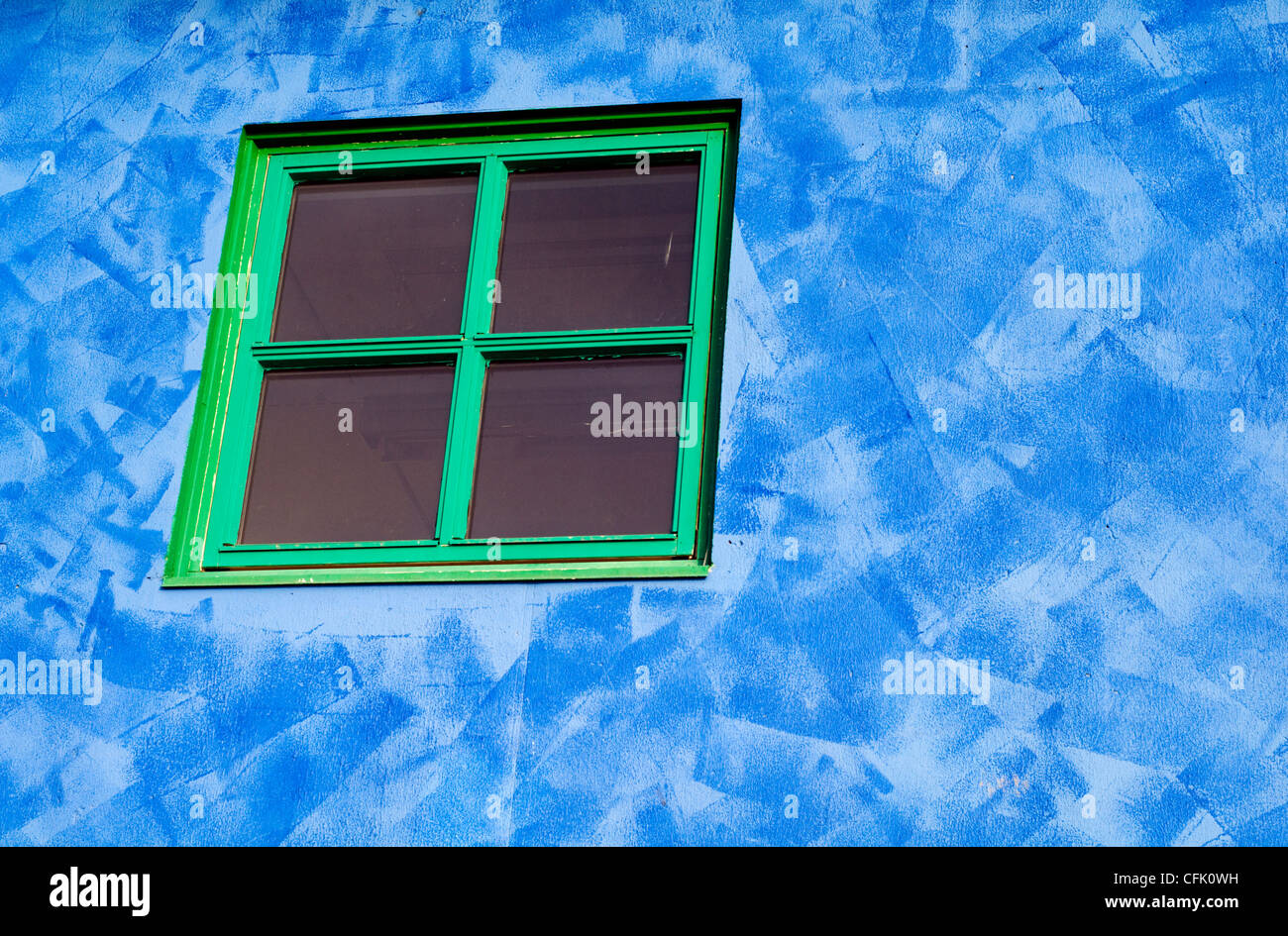 The window frame and exterior blue wall of a building in the town of Sortland in Norway. Stock Photo