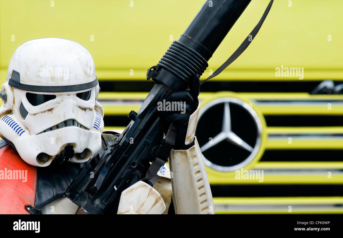 Someone dressed up as a Star Wars stormtrooper standing in front of a Mercedes truck Stock Photo