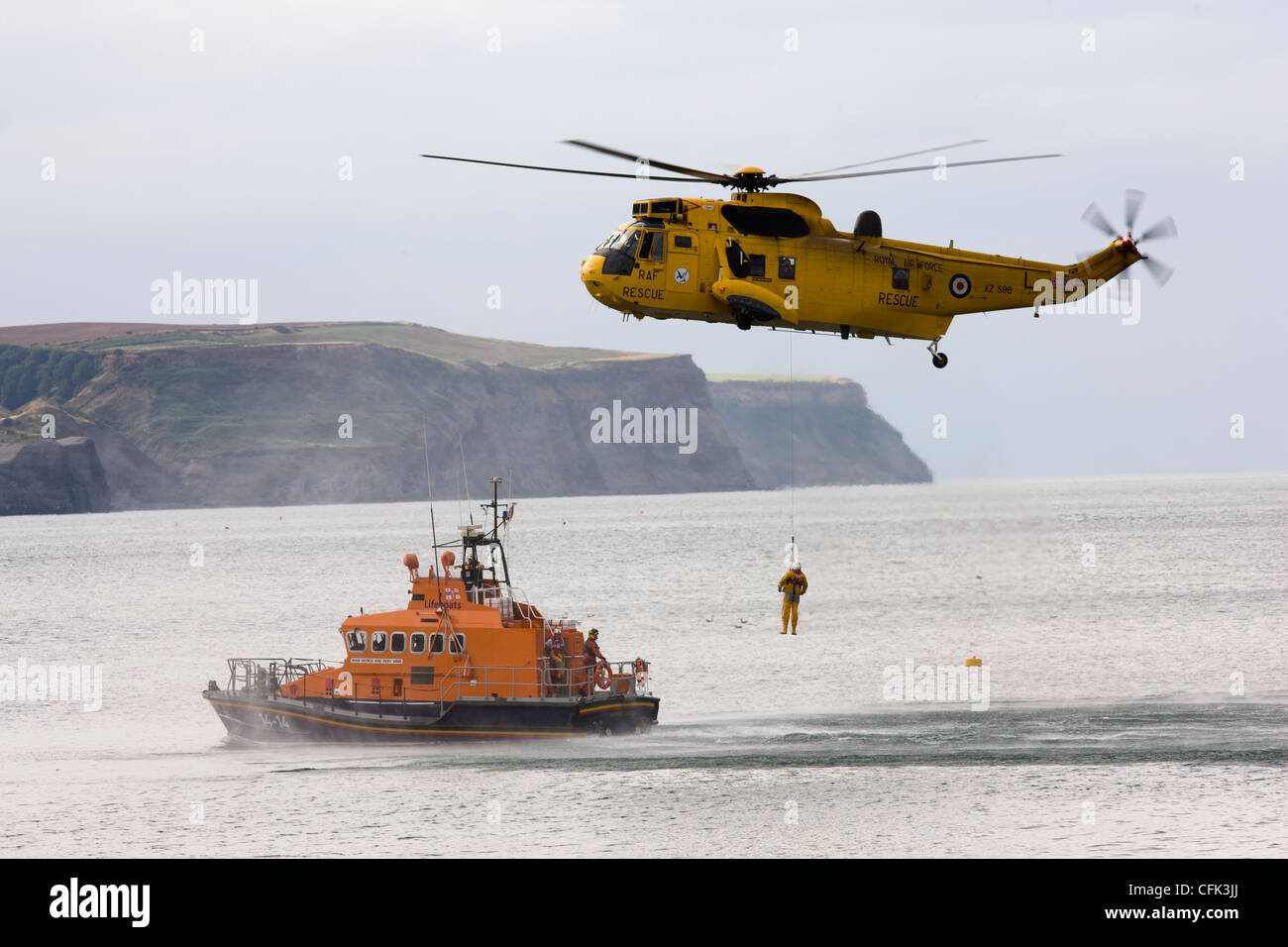 Air-Sea Search and Rescue RAF Sea King helicopter and RNLI lifeboat on winching exercise, Whitby, North Yorkshire Stock Photo