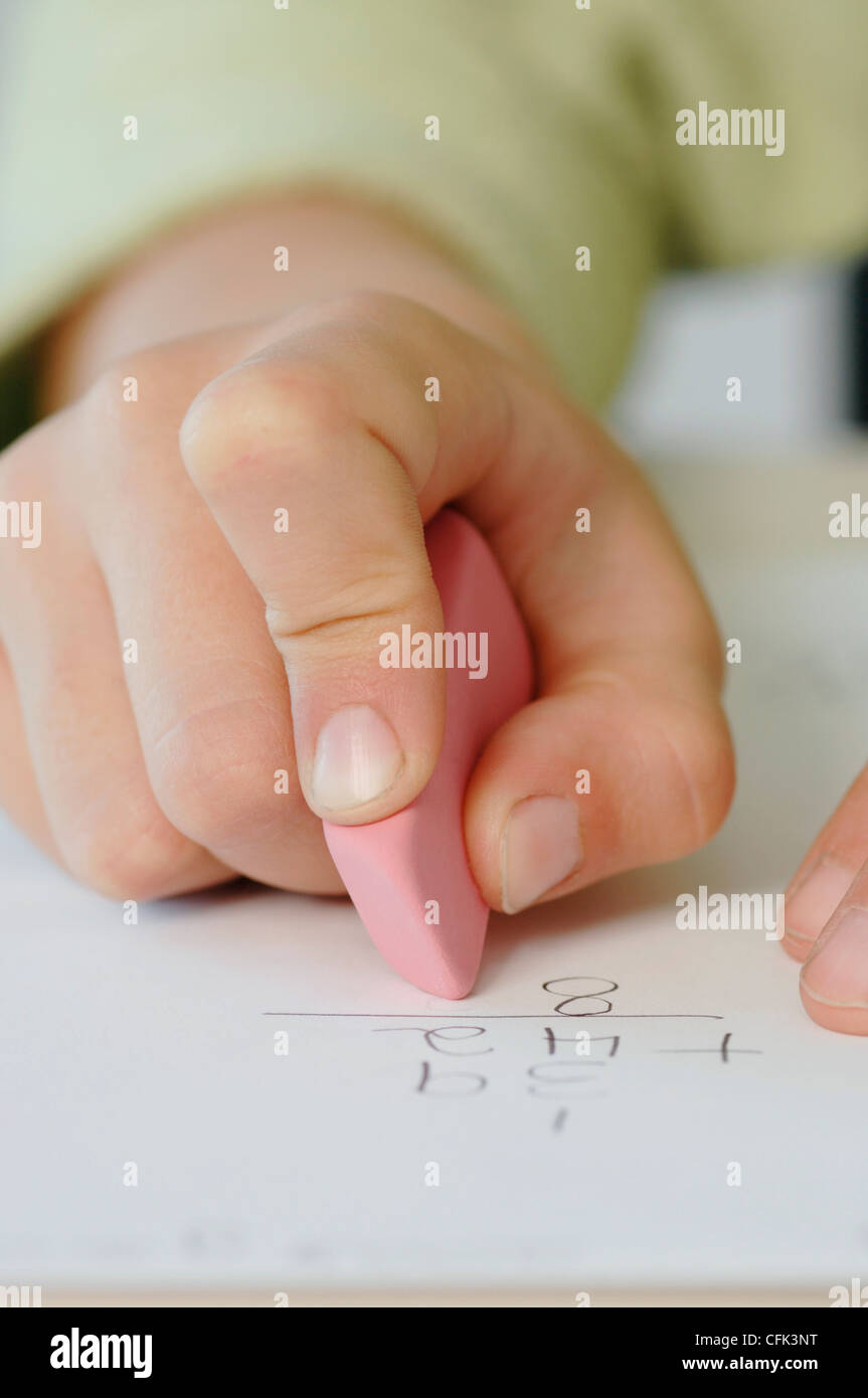 Child Erasing Work from Paper Stock Photo Alamy