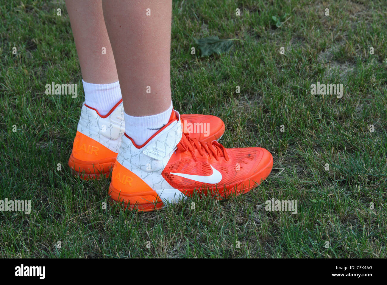 Nike sport shoes worn by teenage boy. Some dirt visible. Stock Photo
