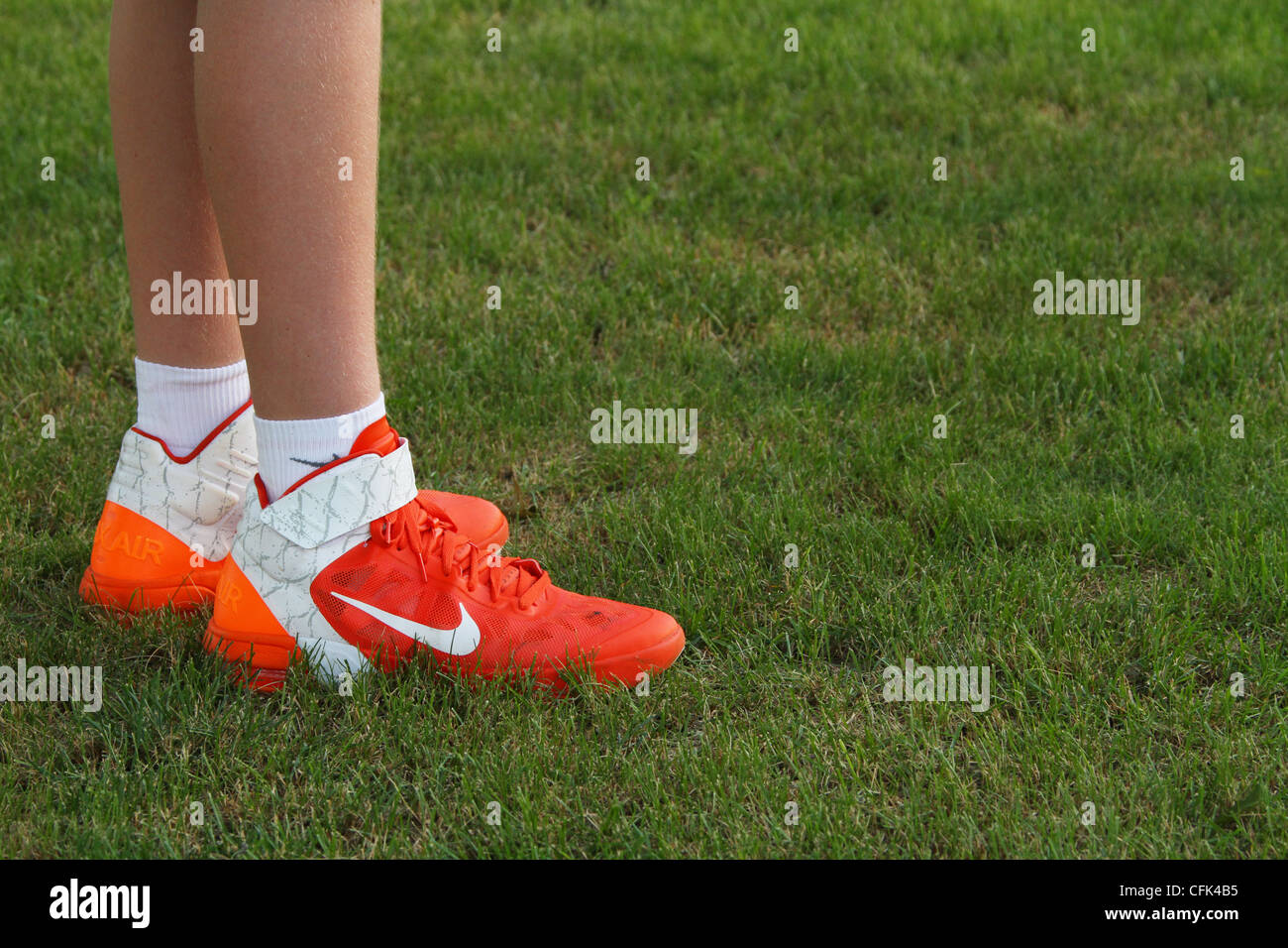 Nike sport shoes worn by teenage boy. Some dirt visible. Stock Photo