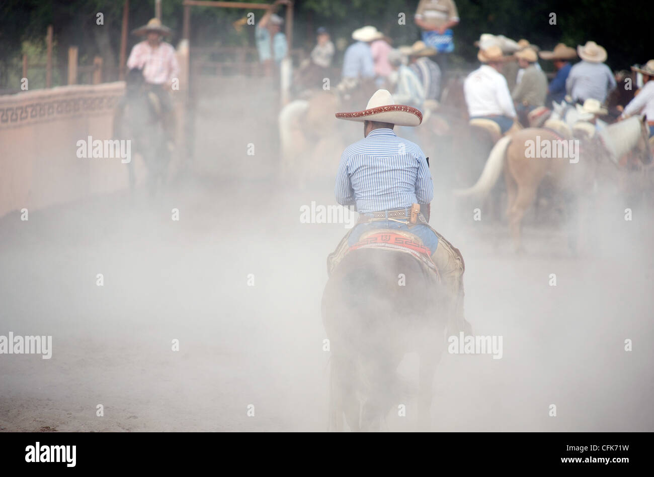 Mexican charros horseman in a break during a coleadero in a dusty lienzo charro (aka arena or ring), San Antonio, TX, US Stock Photo