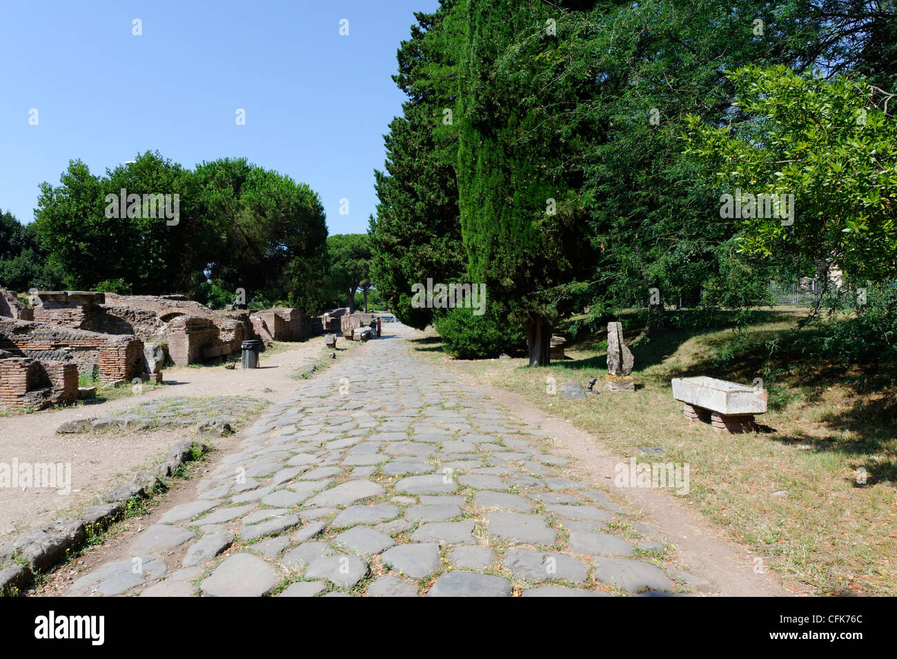 Ostia Antica. Lazio. Italy. View along the upper Decumano Massimo or Decumanus Maximus paved with ancient basalt stone. It is Stock Photo