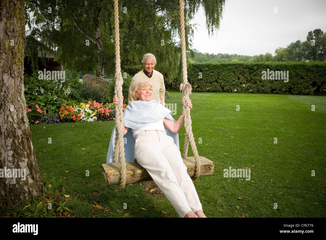 Woman standing behind man sitting hi-res stock photography and images ...