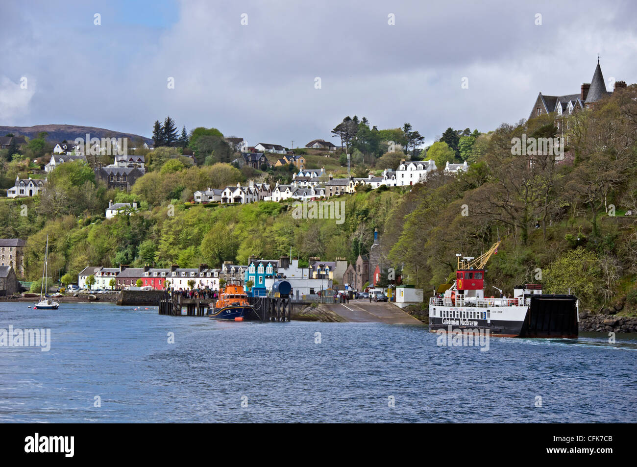View of the small town of Tobermory on the island of Mull in western Scotland from the Sound of Mull with ferry approaching pier Stock Photo