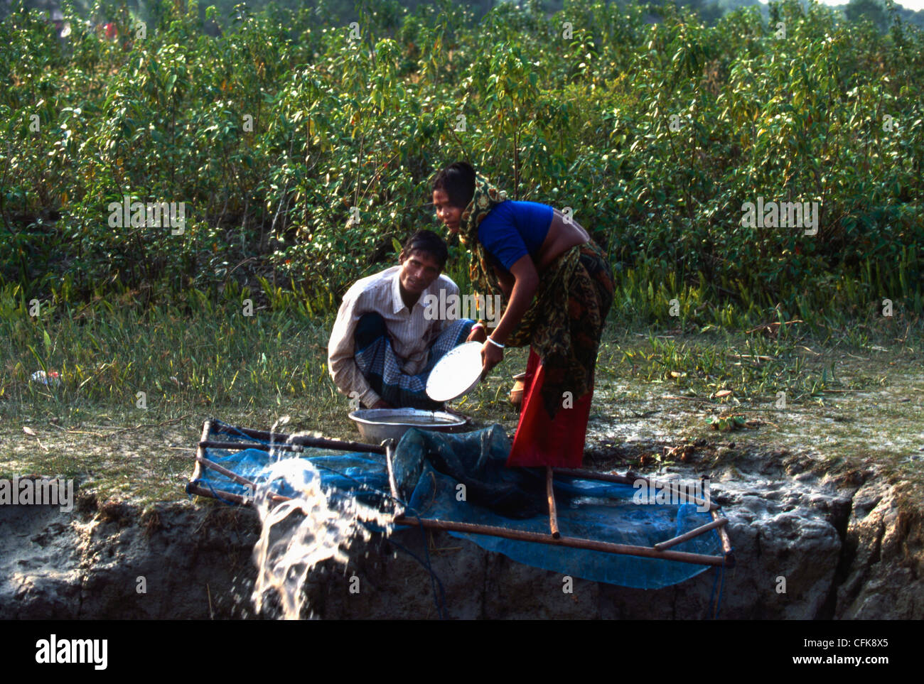 People hunting for Shrimps inside and beside the river of Brahmaputra. Stock Photo