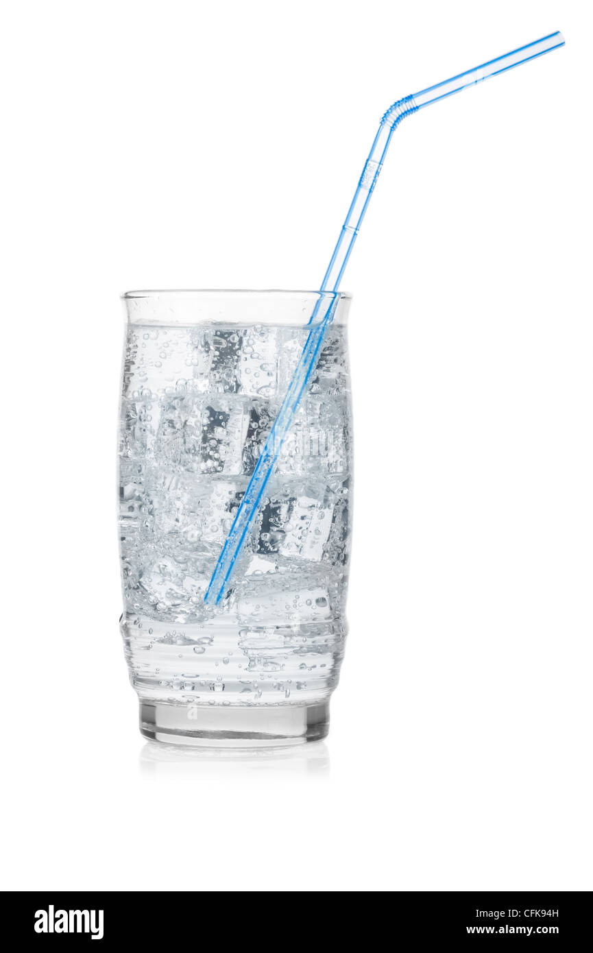 Glass of iced mineral water with straw isolated on white. Stock Photo