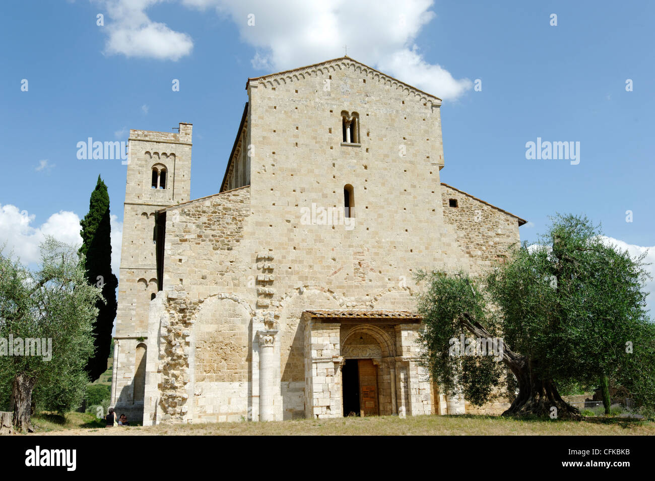 Sant’Antimo. Tuscany. Italy. View of façade of the side of the 12th century abbey church of Sant’Antimo with beautiful setting Stock Photo