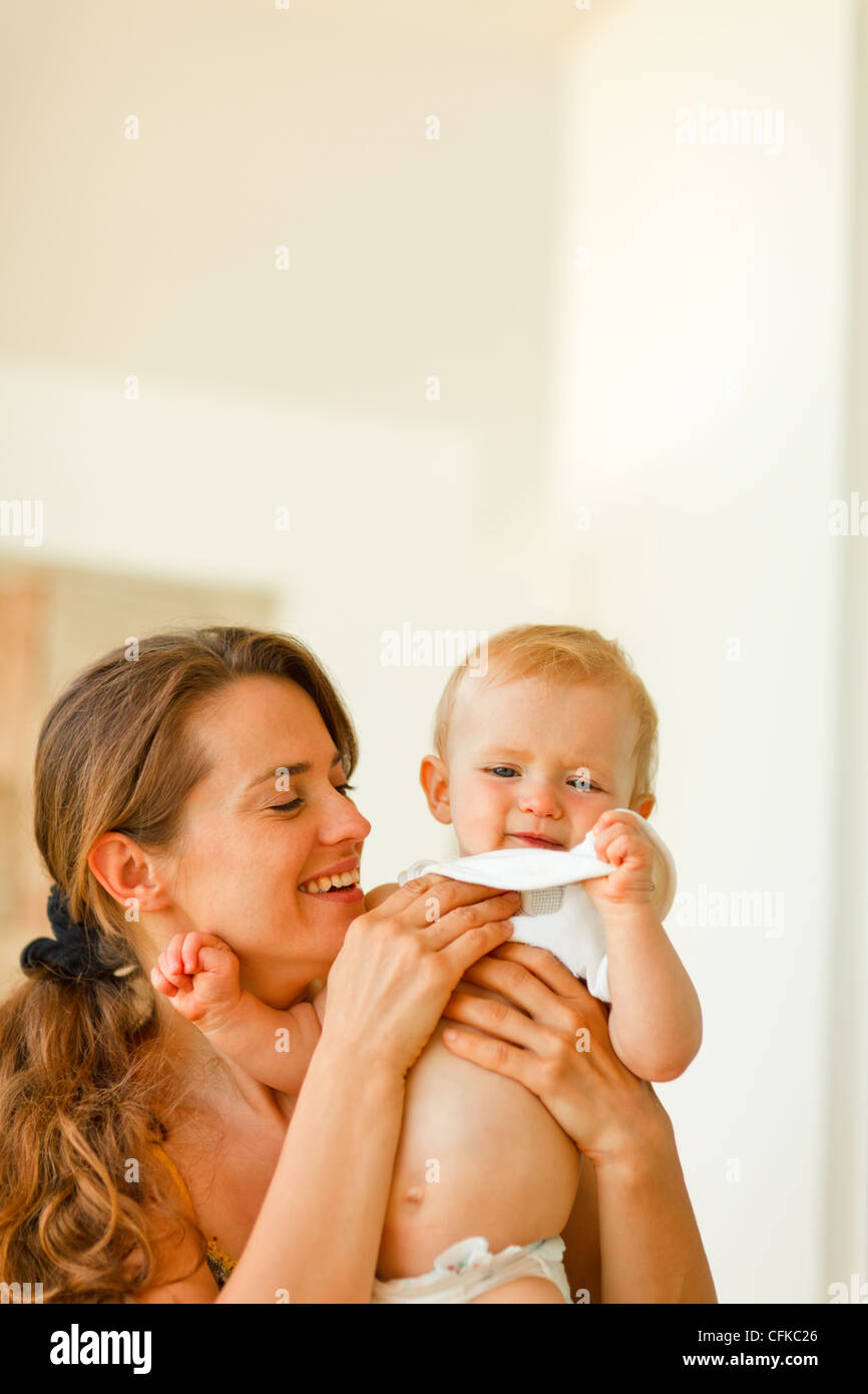 Mother wiping baby after feeding Stock Photo Alamy