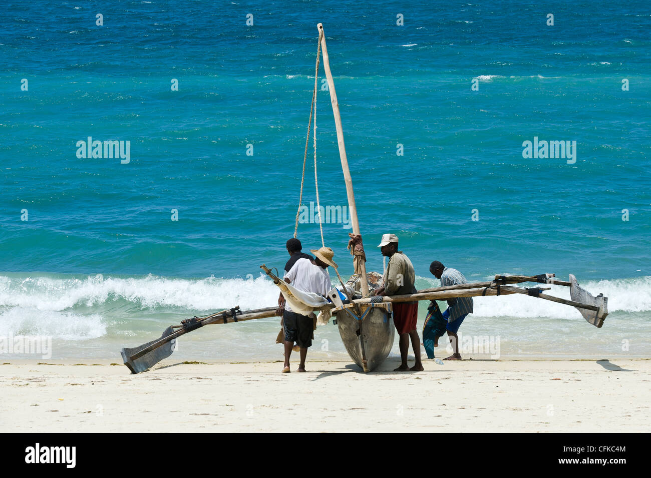 Fishermen with their 'Ngalawa' a traditional double-outrigger canoe, Zanzibar Tanzania Stock Photo