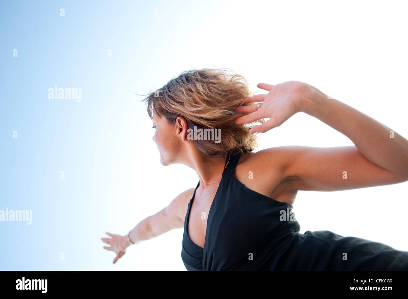 Free flowing woman moving through open space. Stock Photo