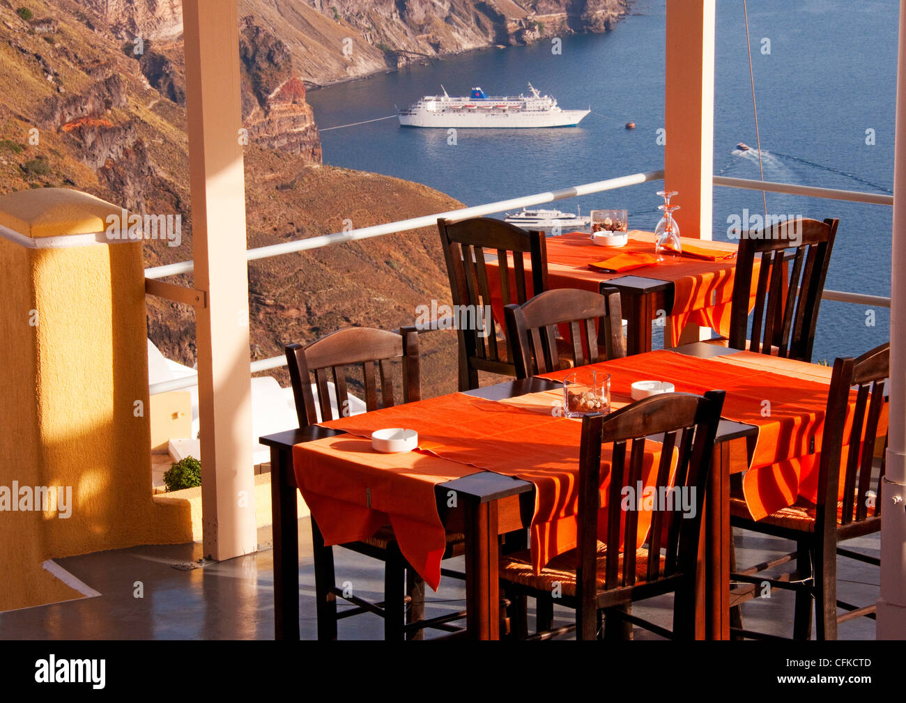 Restaurant tables overlooking Aegean Sea and Santorini, Imerovigli, Santorini, Greece Stock Photo