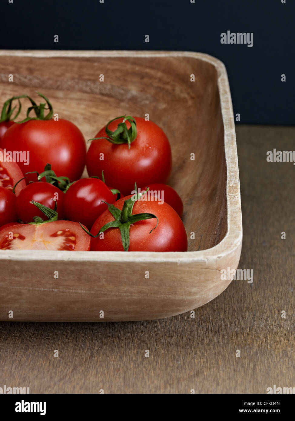 Red Tomatoes In Wooden Bowl Stock Photo - Alamy