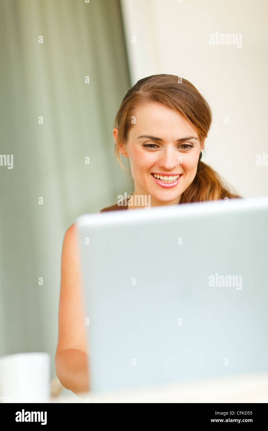 Portrait of beautiful woman working on laptop Stock Photo - Alamy