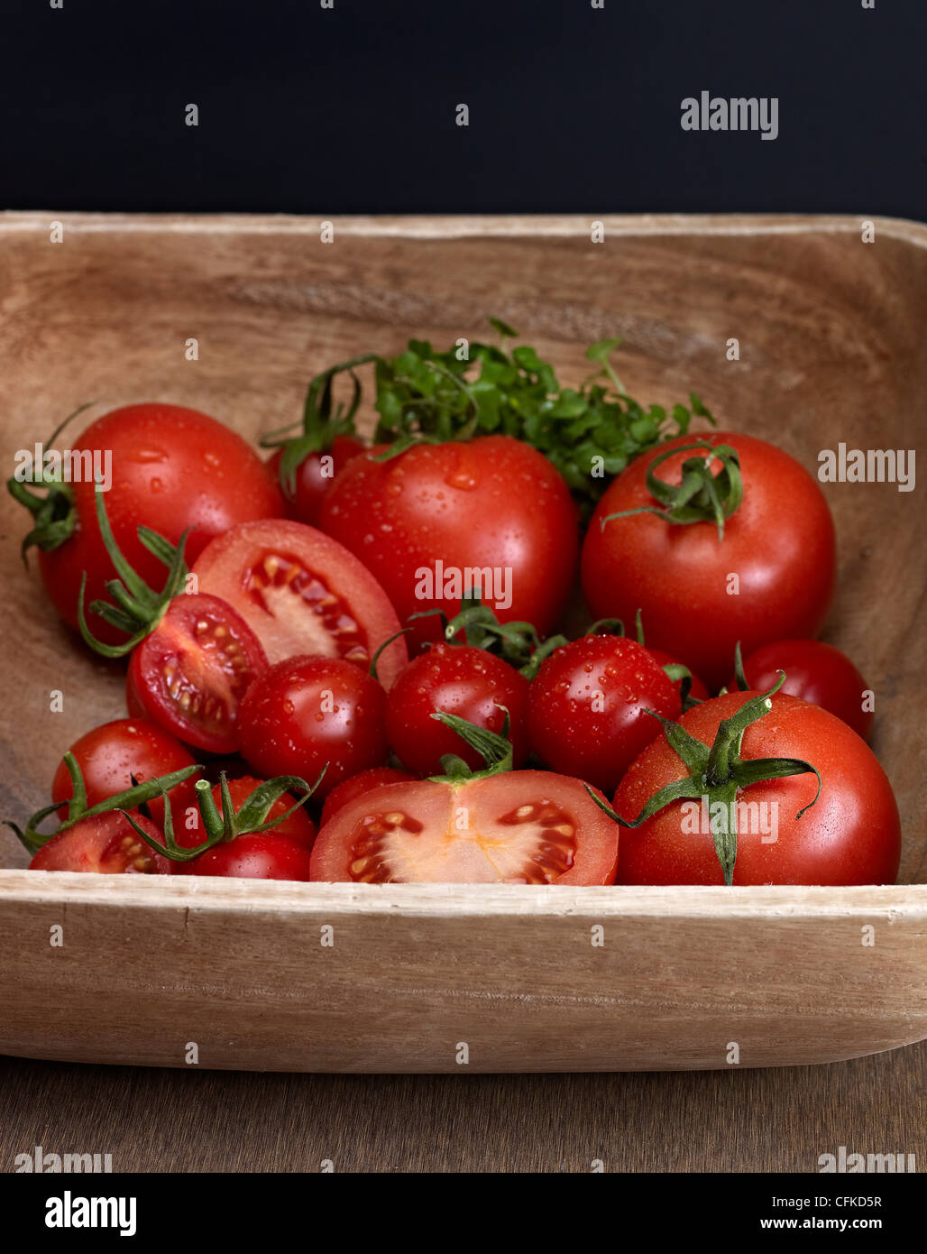 Red Tomatoes In Wooden Bowl Stock Photo - Alamy