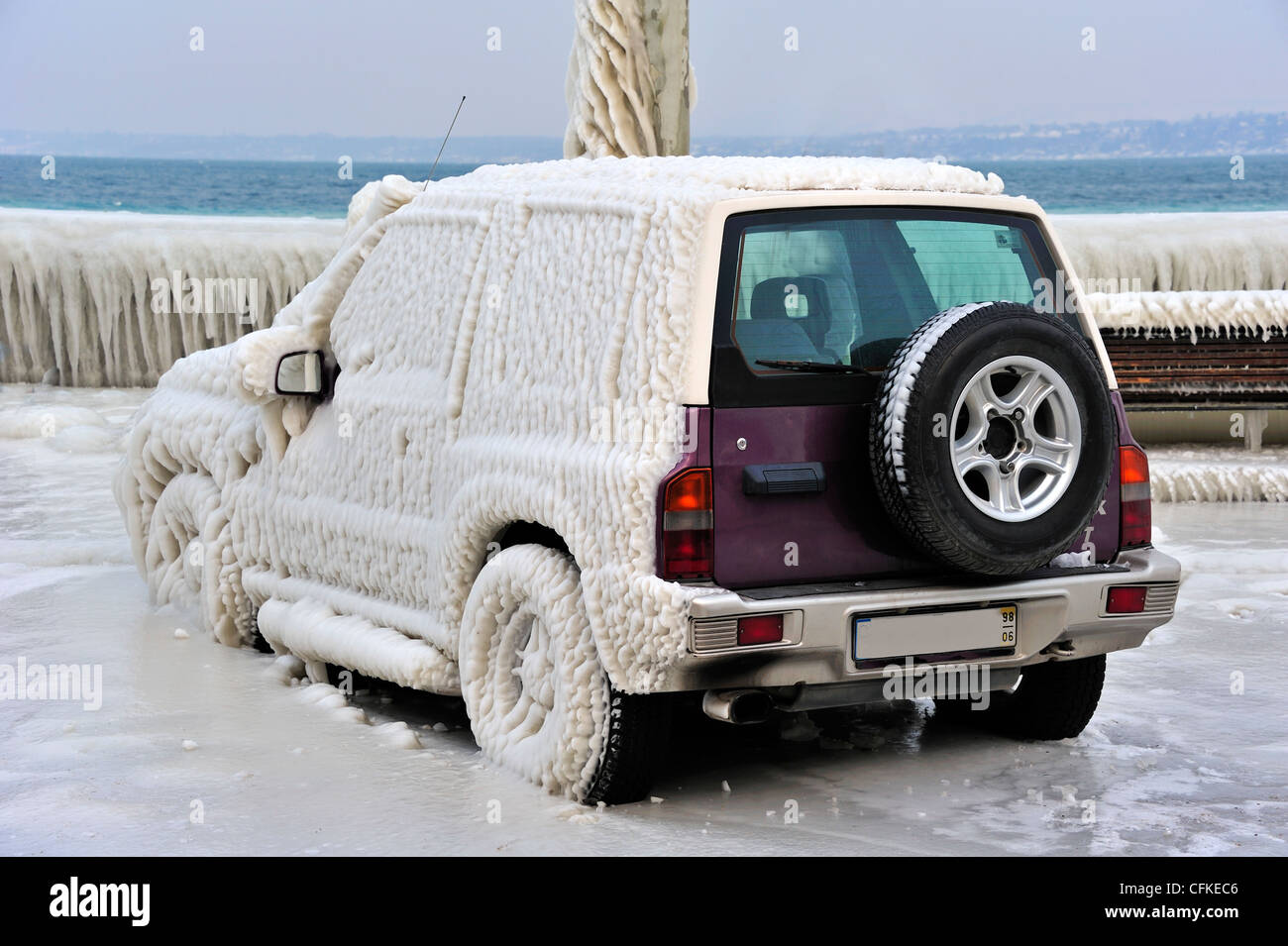 Car frozen in ice in Versoix, Switzerland, by Lake Geneva Stock Photo