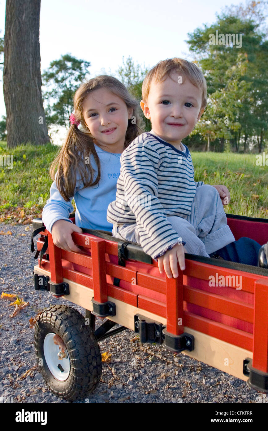 Brother and Sister Playing in Wagon Stock Photo - Alamy