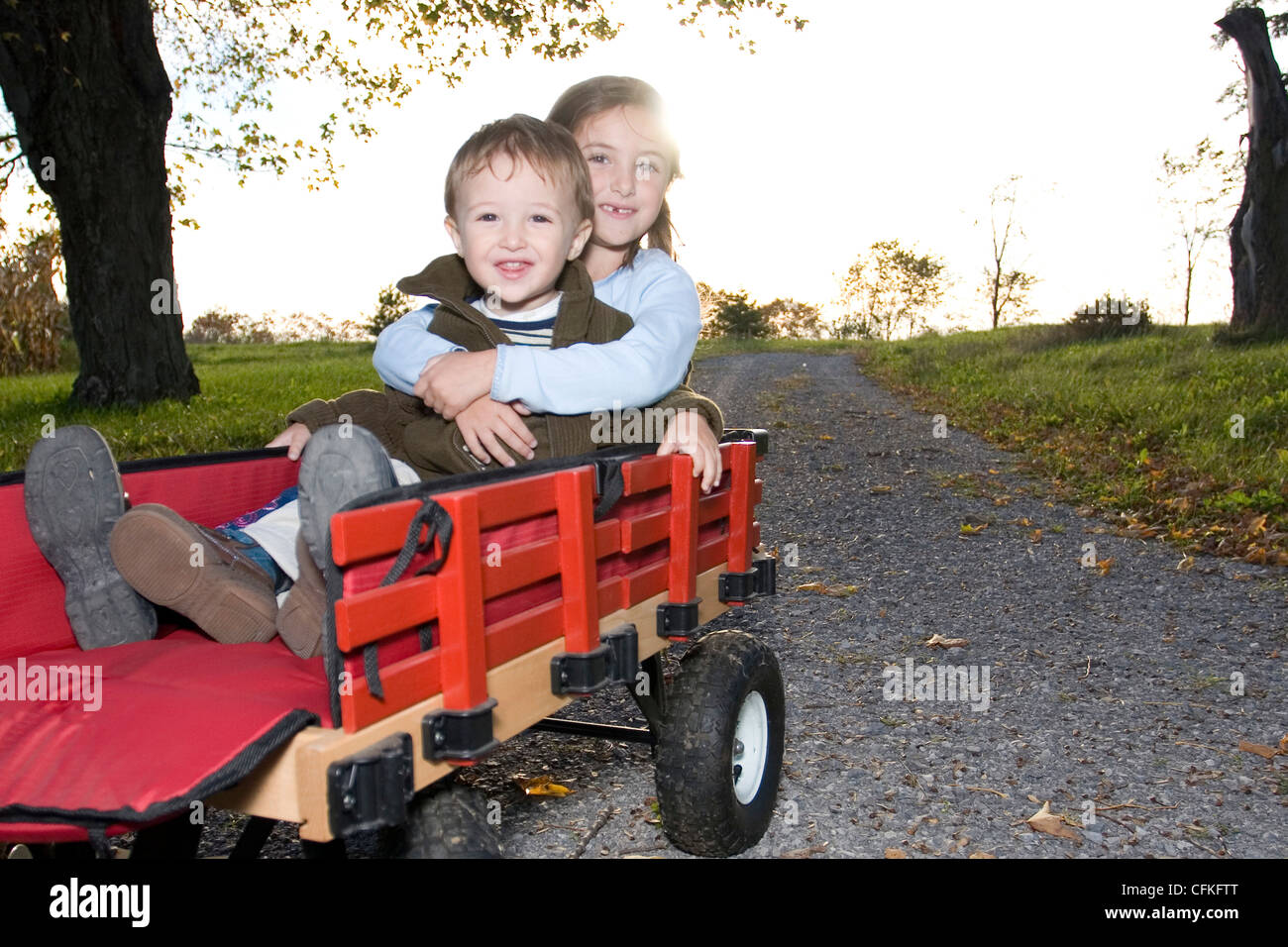 Brother and Sister Playing in Wagon Stock Photo - Alamy