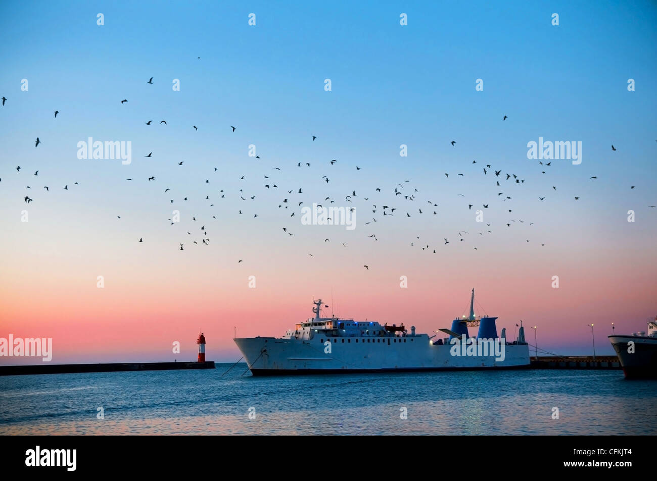 Dawn against the sea and the ships Stock Photo - Alamy