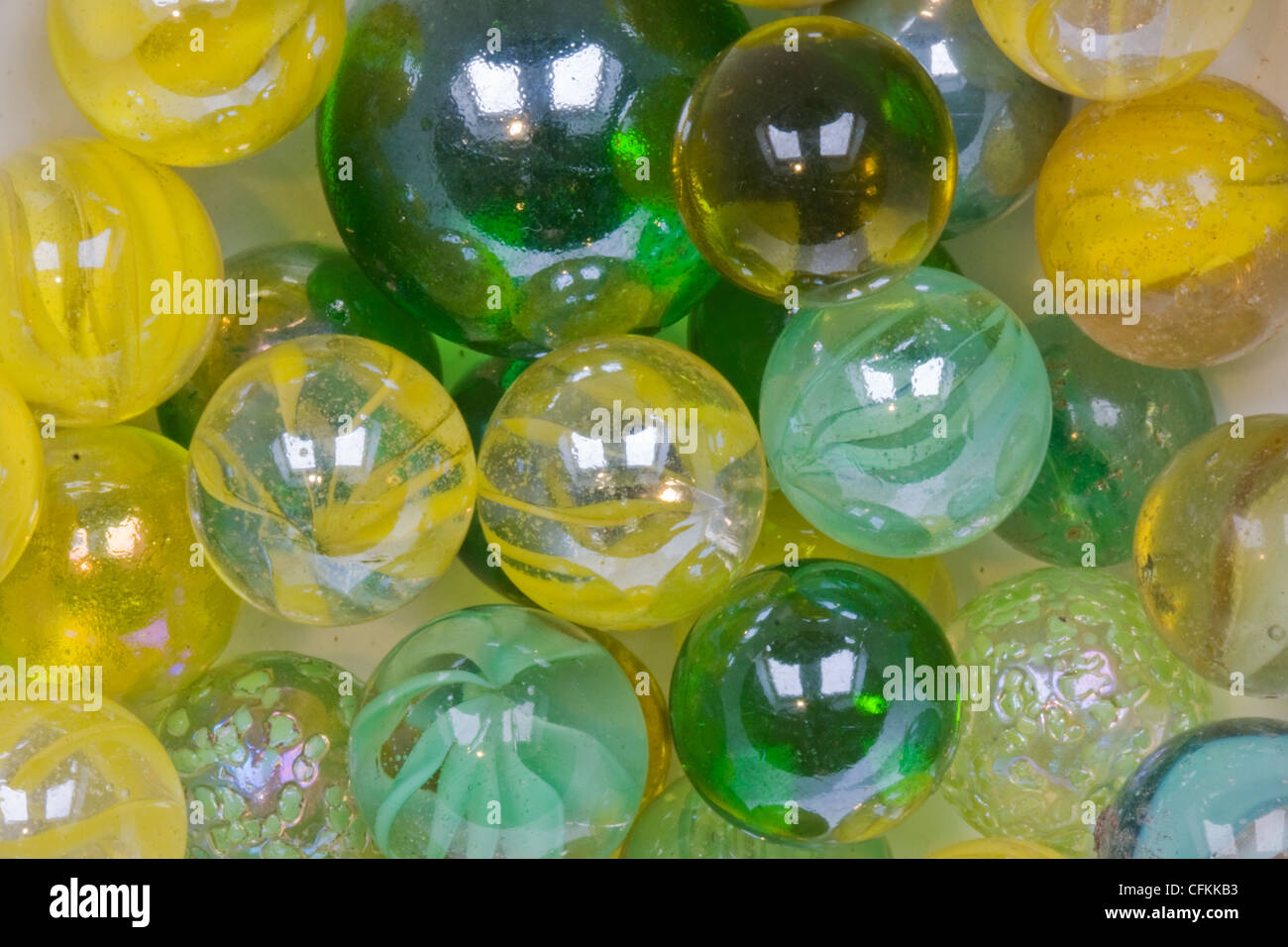 Yellow and green glass marbles Stock Photo