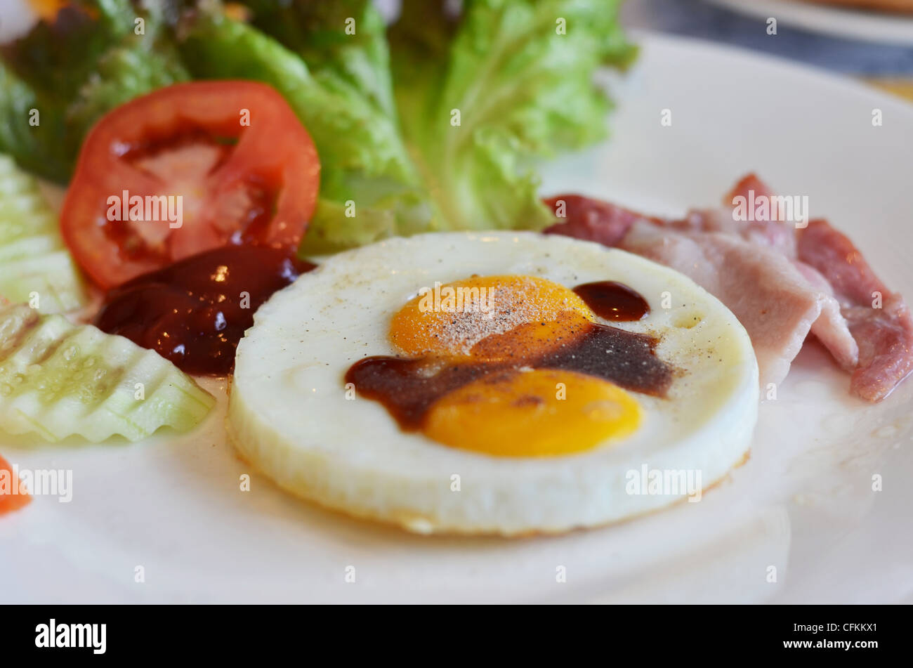 american style breakfast , with bacon, fried egg and fresh vegetables
