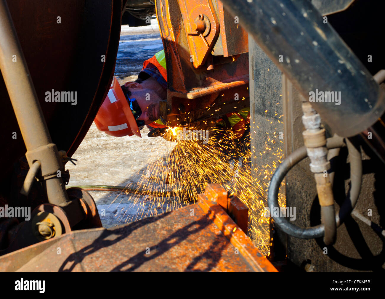 Welder welding snow plow Stock Photo
