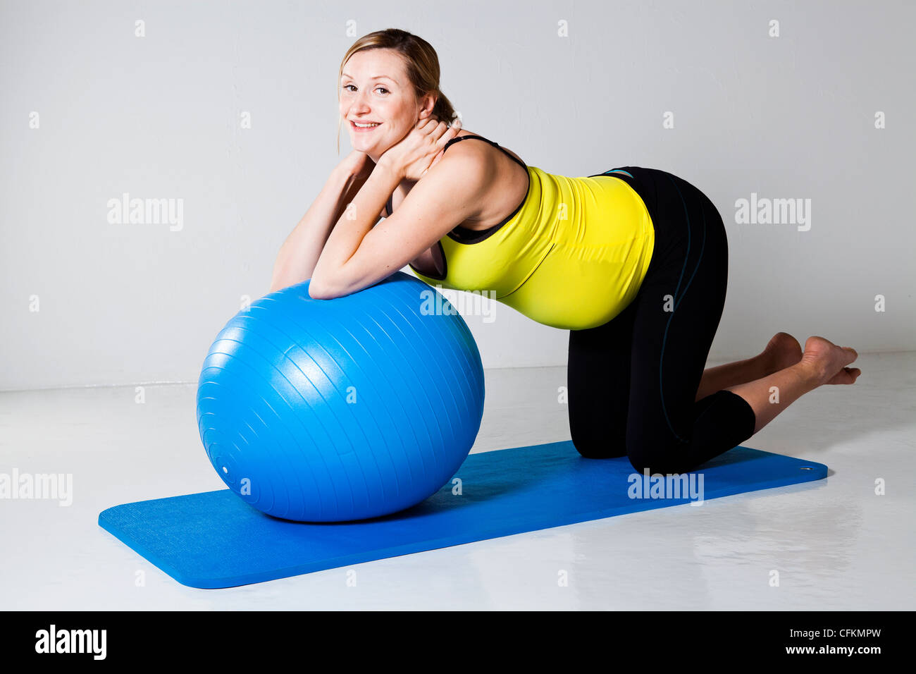 Pregnant woman doing an abdominal core strengthening exercise using a
