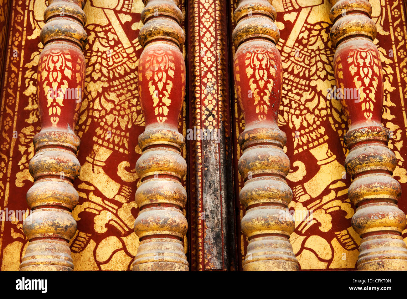 Detail of Wat Saen Vat Sene showing decorative carving and red and gilt painting in one of Luang Prabang's many Buddhist Temples Stock Photo