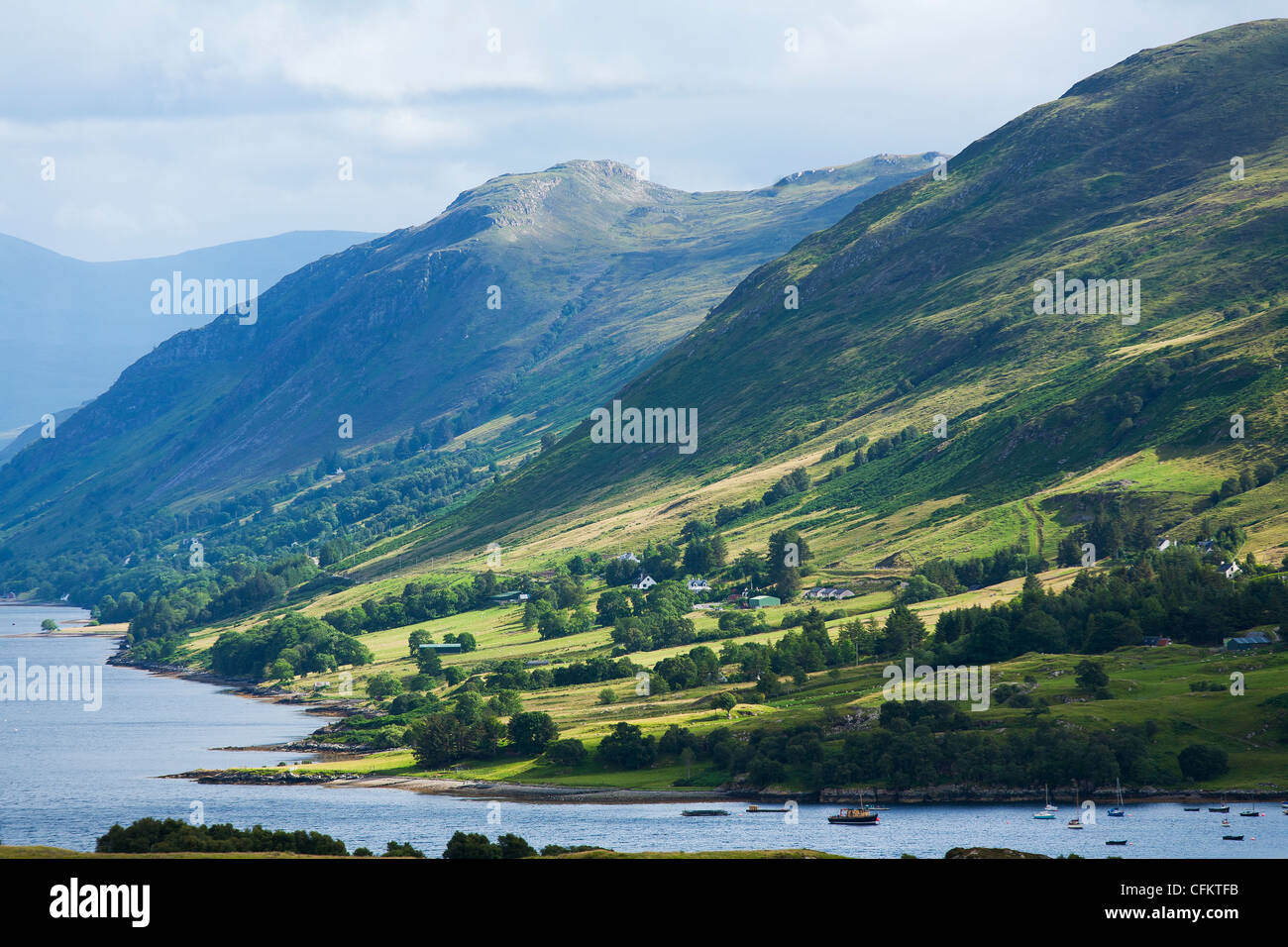 A view over Ullapool, looking up Loch Broom in Western Scotland with mountains in the background. Stock Photo