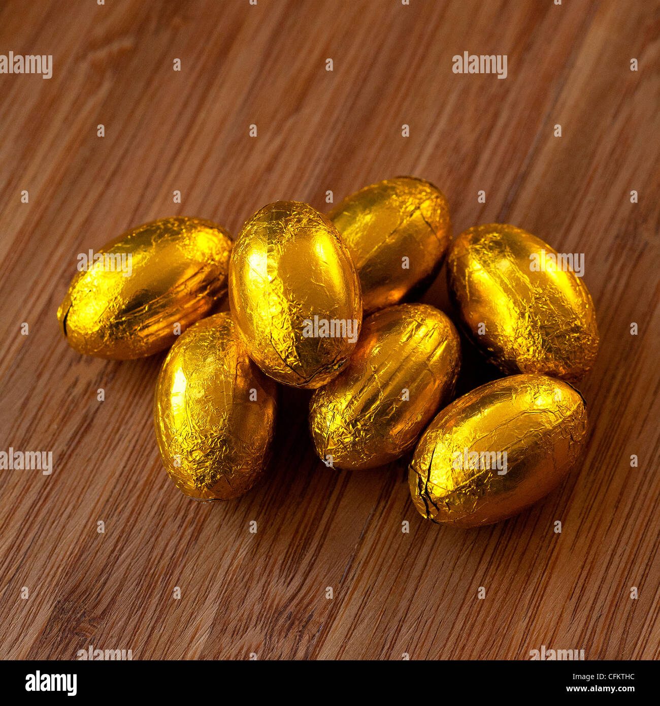 Golden eggs, symbolic in stories as wealth and profit, in reality chocolate sweets a delight at Easter and Christmas. Stock Photo