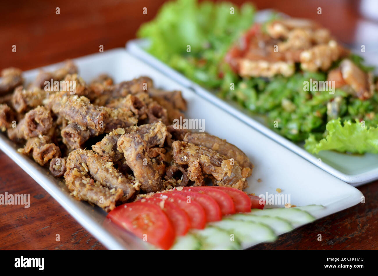 deep fried Pork's colon with garlic served with fresh vegetable Stock Photo