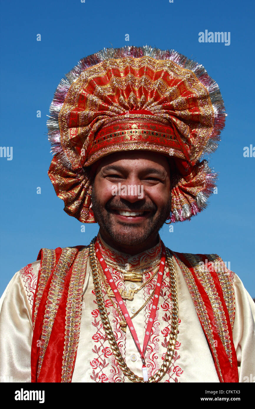 Traditional Punjabi dress and headdress as worn by a Dholi - or drummer - in Birmingham UK Stock Photo