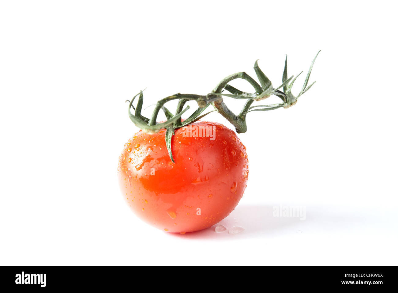 Red tomato with green leaves on a white background Stock Photo - Alamy
