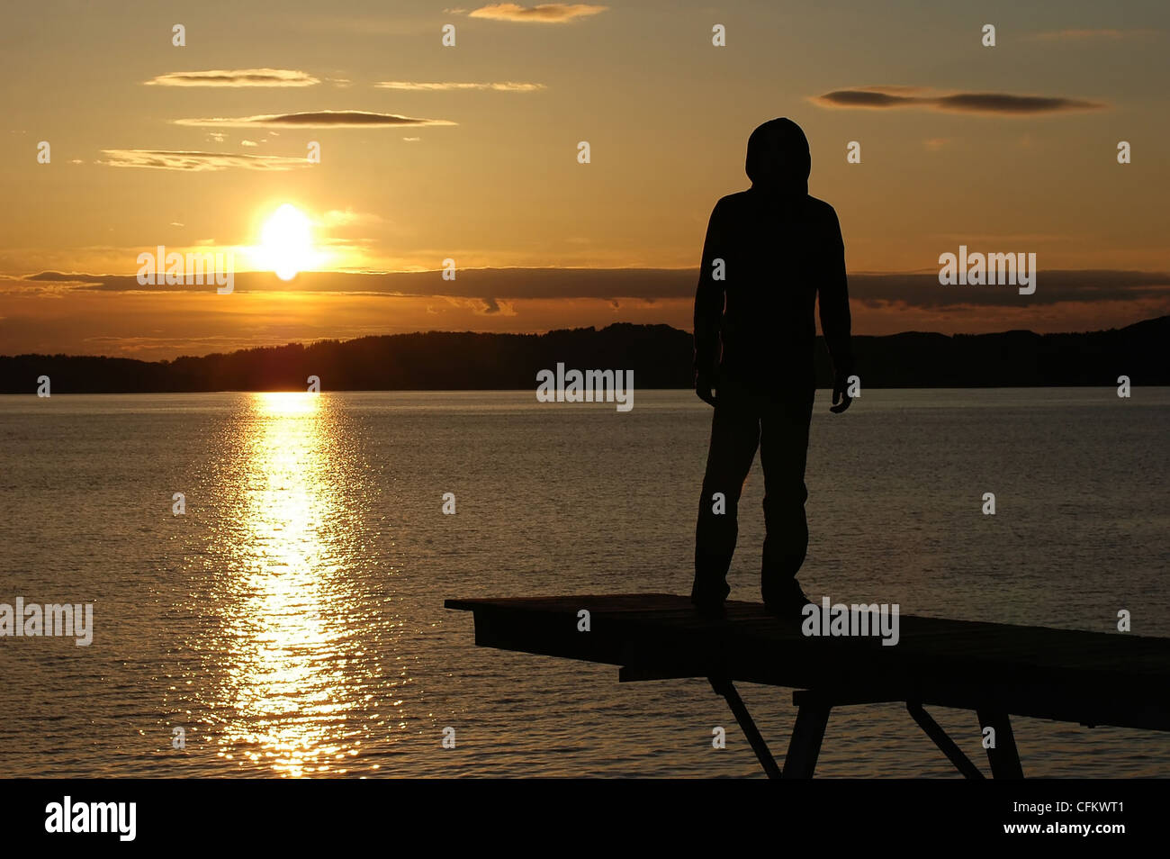 Silhouette man in hood standing hi-res stock photography and images - Alamy