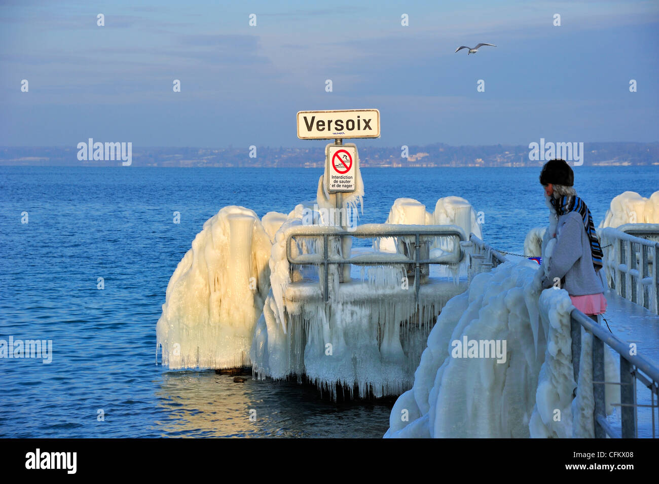 The jetty at Versoix, Lake Geneva, covered with ice. The figure in the image is not a person but a shop-window dummy. Stock Photo