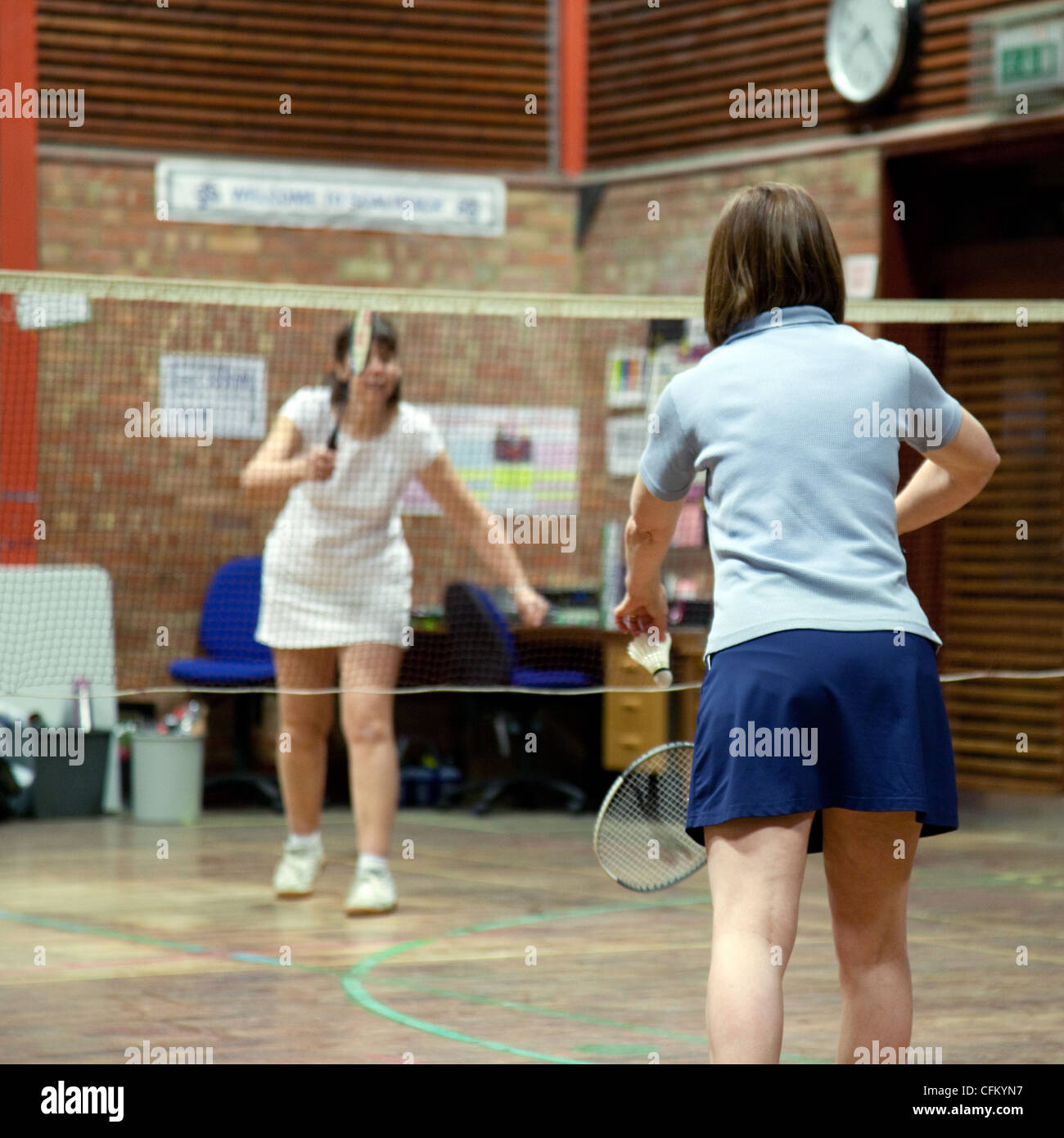 Two women playing badminton at their local club, Newmarket Suffolk UK Stock Photo