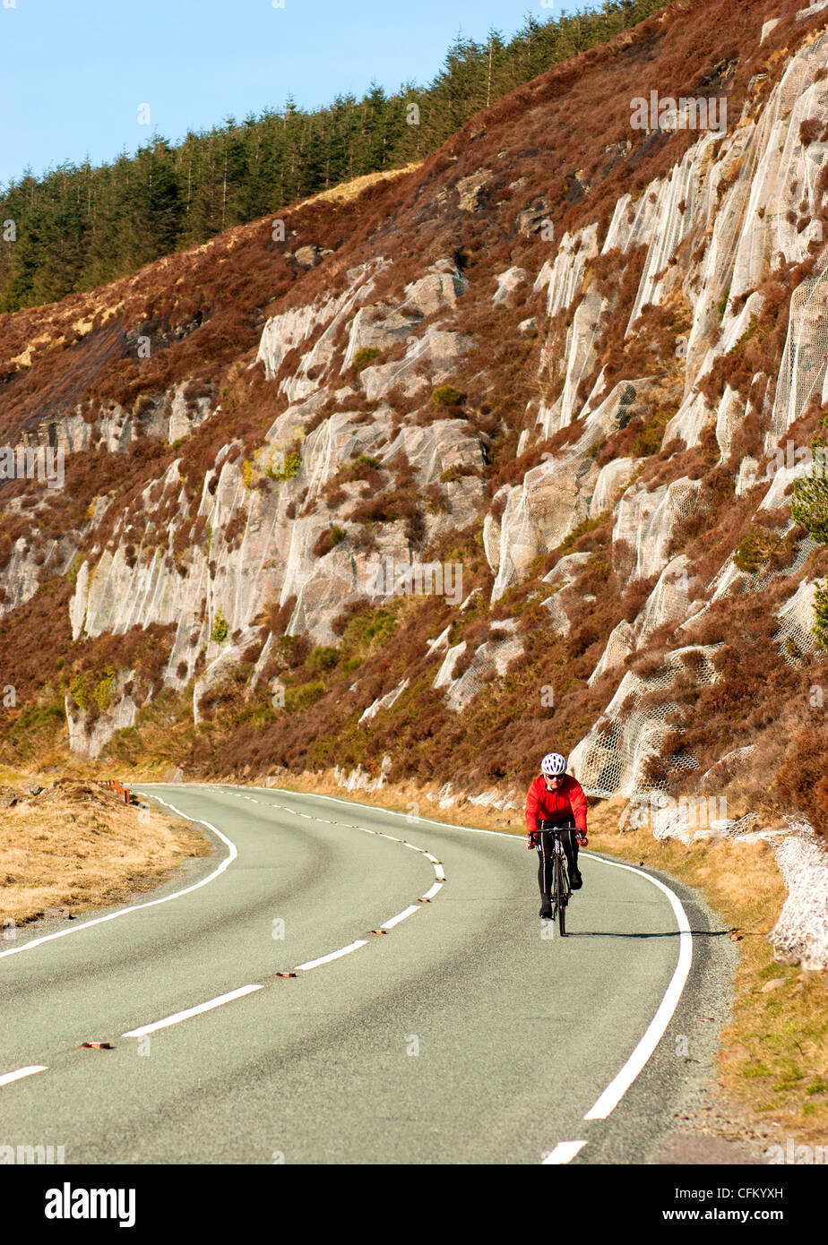Cyclist on a mountain road in the Rhondda Valleys, South Wales, UK Stock Photo