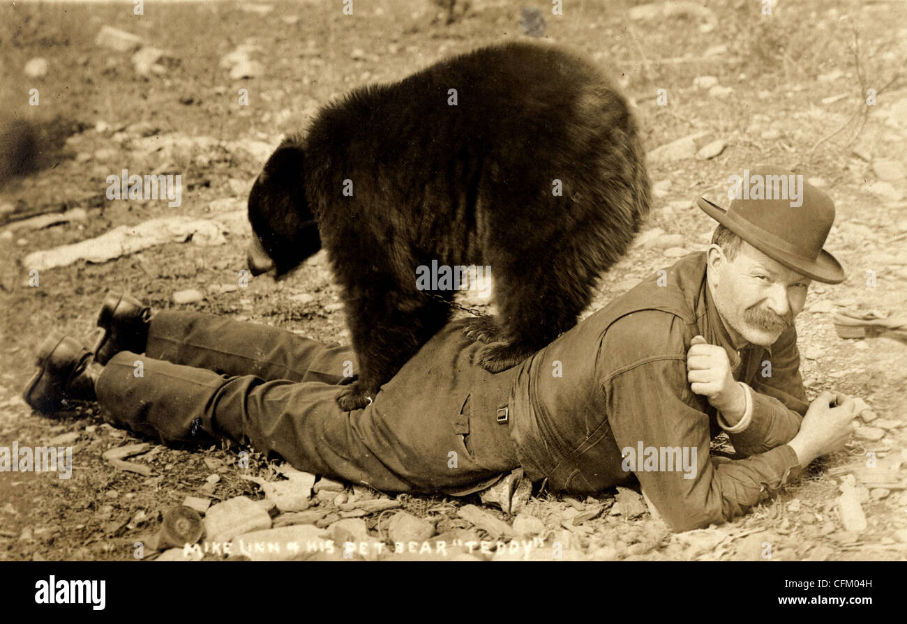 Friendly Pet Bear Standing on his Owner Stock Photo