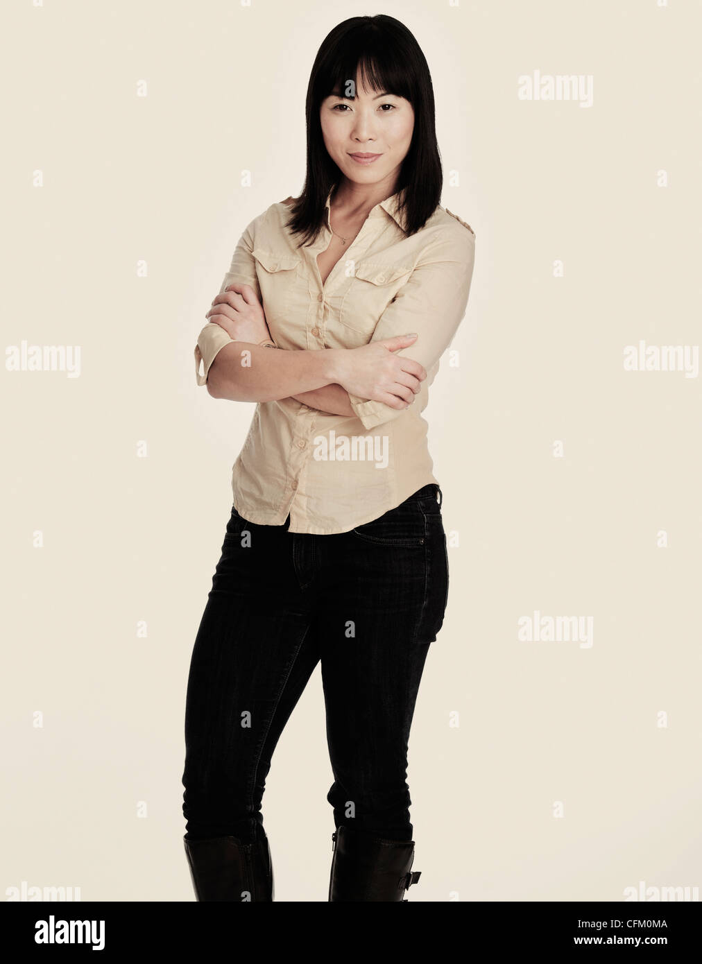 Standing woman crossing arms hi-res stock photography and images - Alamy