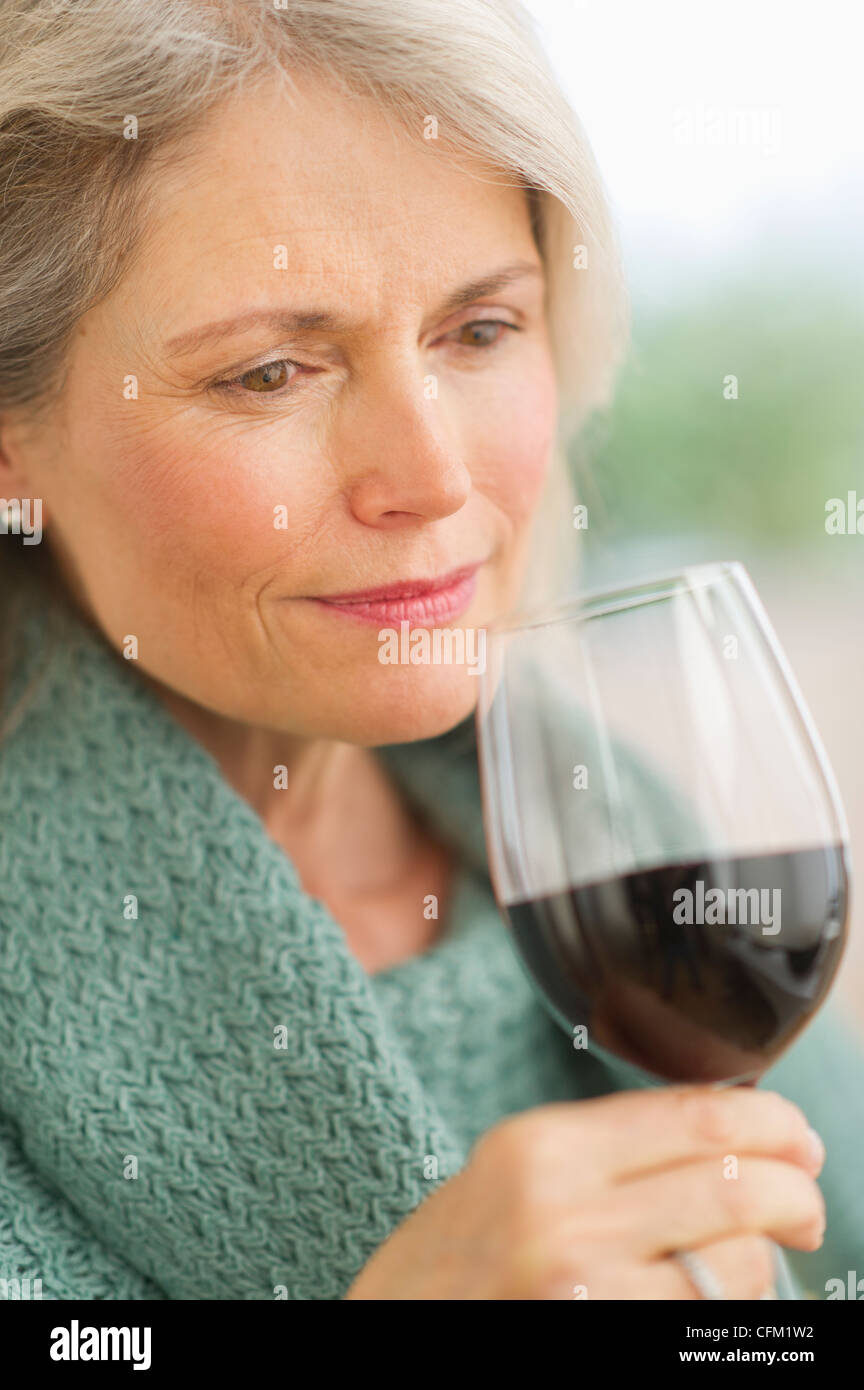USA, New Jersey, Jersey City, Senior female connoisseur tasting red wine Stock Photo