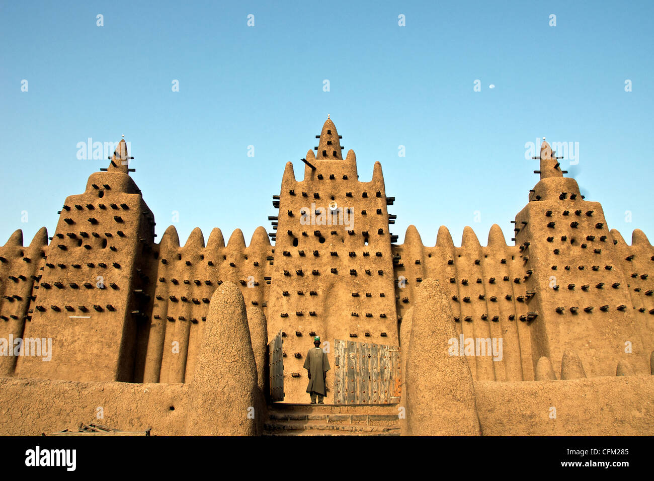 A man stands at the gates of the Great Mosque of Djenne in Djenne, Mali. Stock Photo