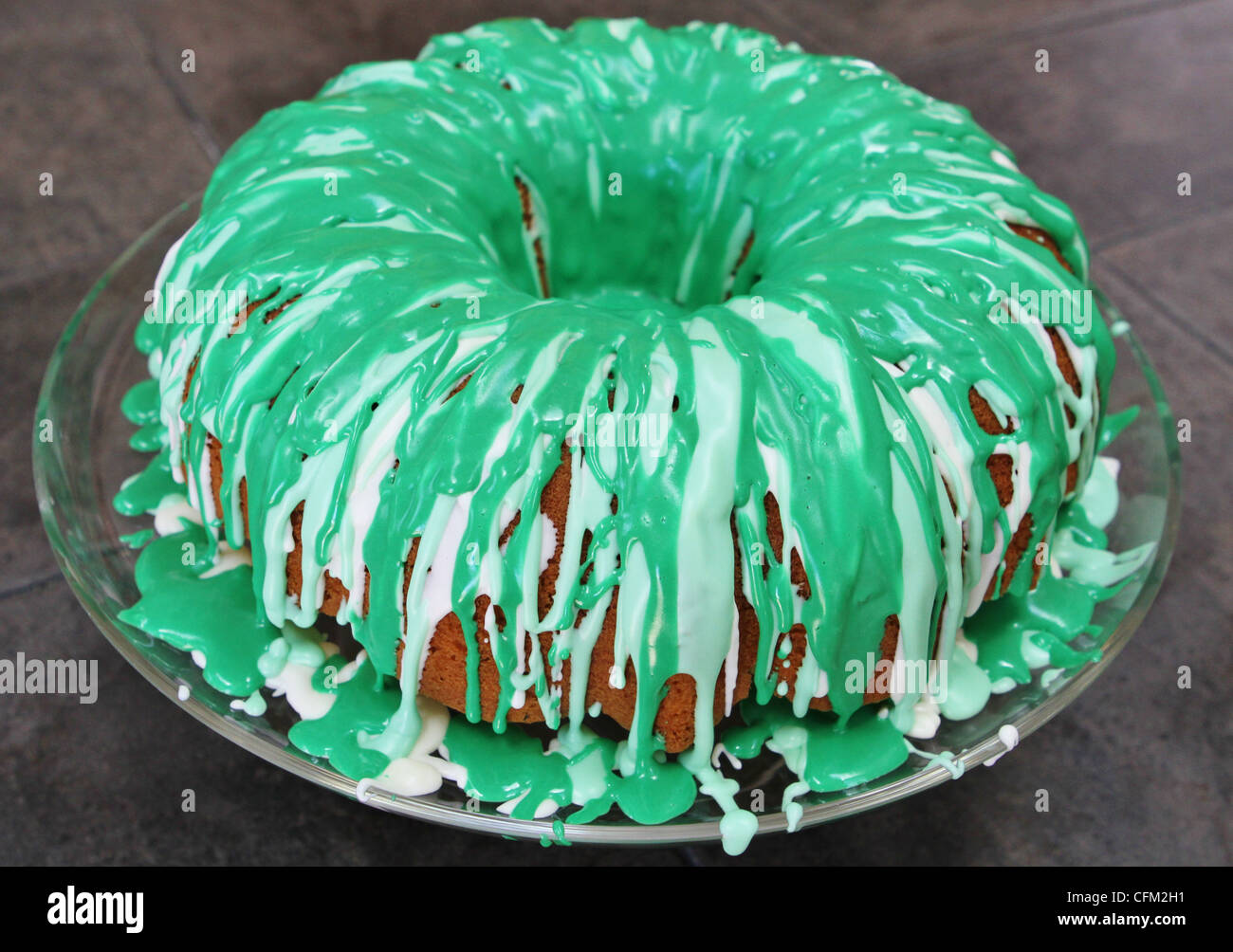 A green bundt cake covered in frosting Stock Photo Alamy
