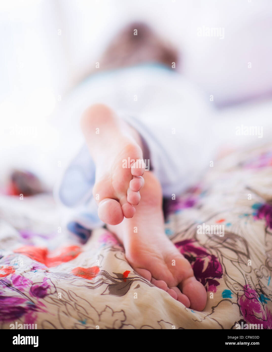 USA, New Jersey, Jersey City, Closeup of woman's feet lying on bed