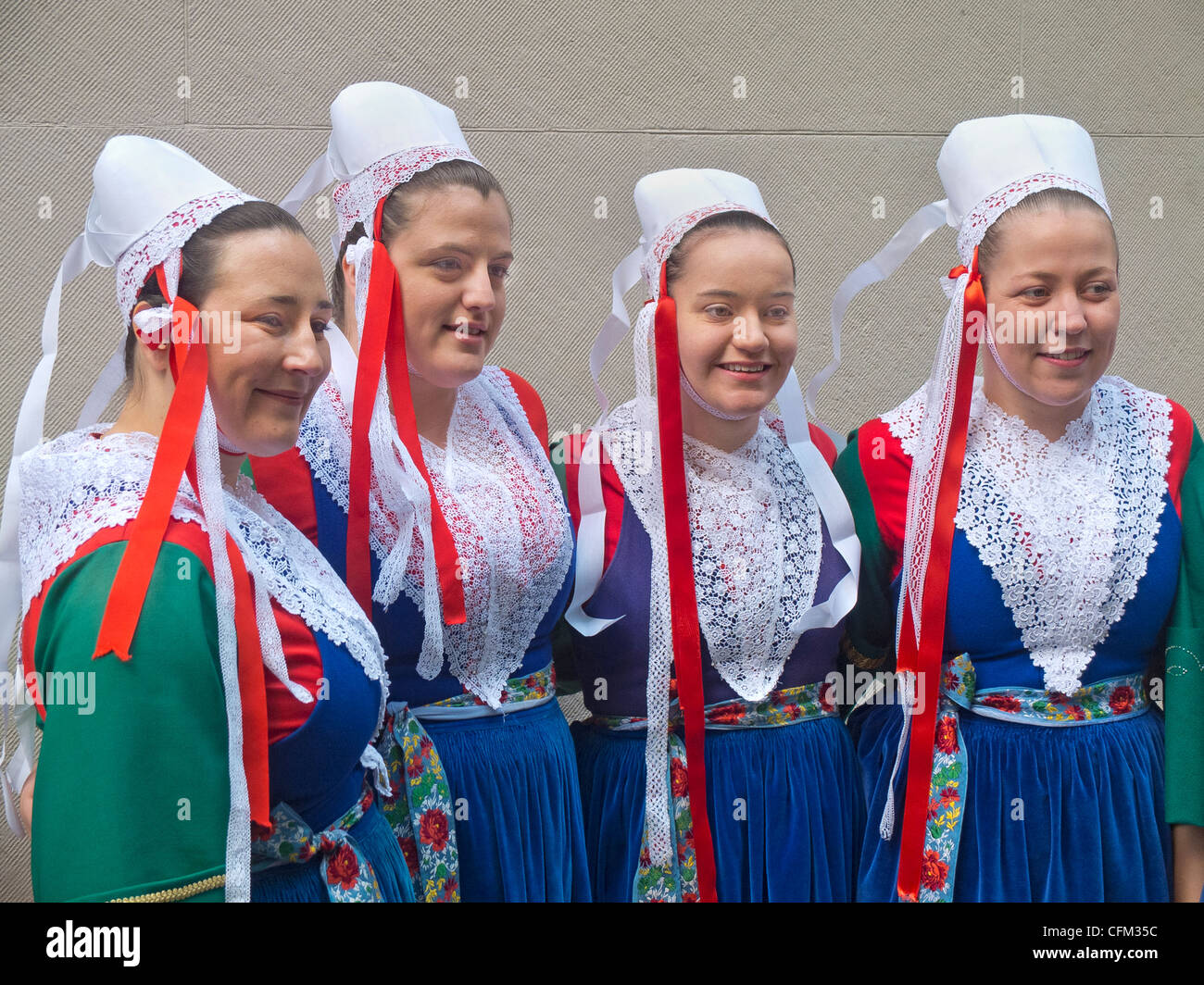 adults dressed in traditional French costumes at the Tartan day parade