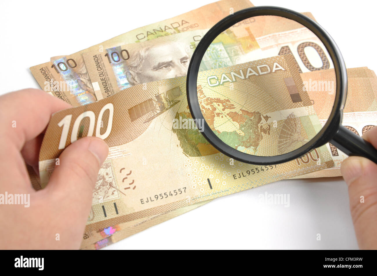 Magnifying glasses with Canadian Dollar Stock Photo