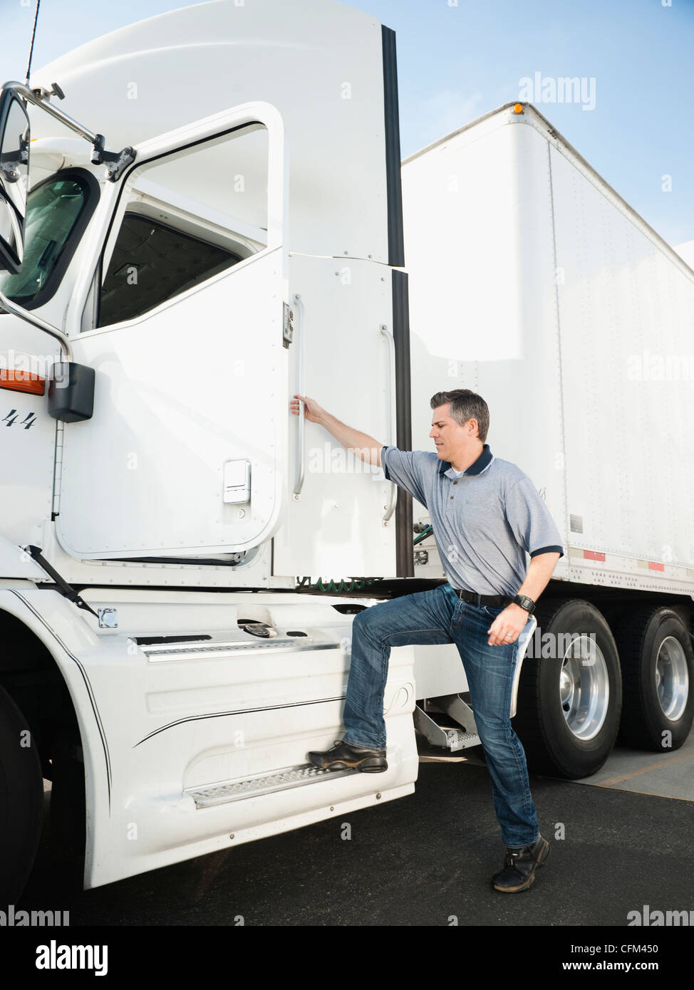 Relaxed Caucasian Truck Driver Seating on the Ground and Support His Back  on the Semi Truck Wheel Stock Photo - Alamy